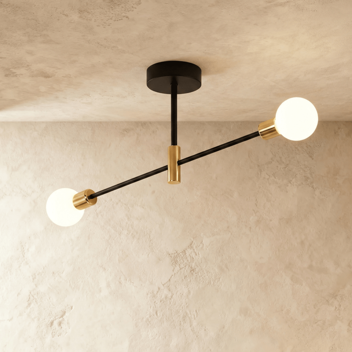 Clérachic 2-arm iron ring chandelier in black with brass sockets, frosted globe bulbs lit against a plaster ceiling.