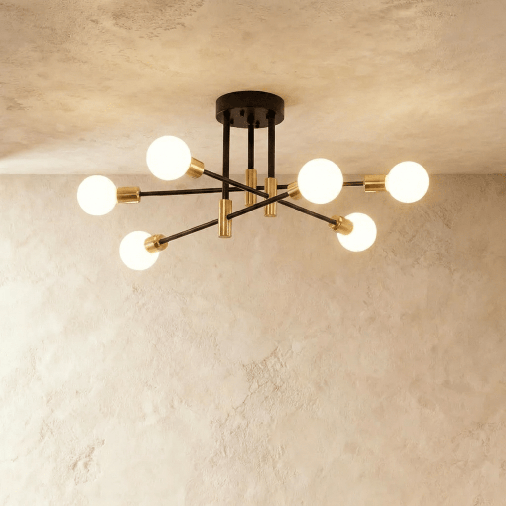 Clérachic 6-arm iron ring chandelier in black with brass sockets, frosted globe bulbs lit against a plaster ceiling.