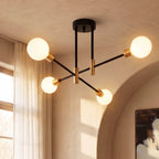 Clérachic 4-arm iron ring chandelier in black and brass, lit beside a sheer-curtained window and an arched doorway.
