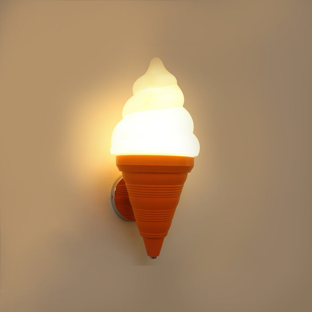 Orange-coned Clérachic wall light lit in a warm amber tone on a tan wall, the swirl shade softly glowing from within.