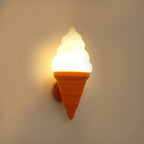 Orange-coned Clérachic wall light lit in a warm amber tone on a tan wall, the swirl shade softly glowing from within.
