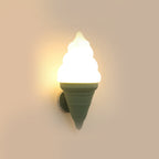 Green-coned Clérachic wall light lit in a warm tone on a sand-coloured wall, the swirl shade glowing a soft yellow-white.