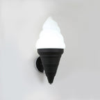 Black-coned Clérachic wall light lit in cool white on a light grey wall, the swirl shade bright above a ribbed cone and chrome backplate.