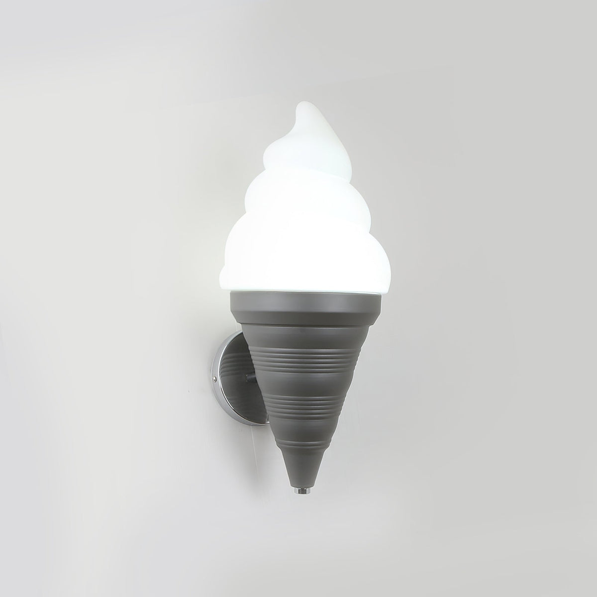 Grey-coned Clérachic wall light lit in cool white on a pale wall, with a ribbed cone and a chrome backplate behind it.