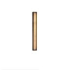 The Clérachic Isolde lit warm from a slight angle, alabaster glowing along the full length of its bronze housing.