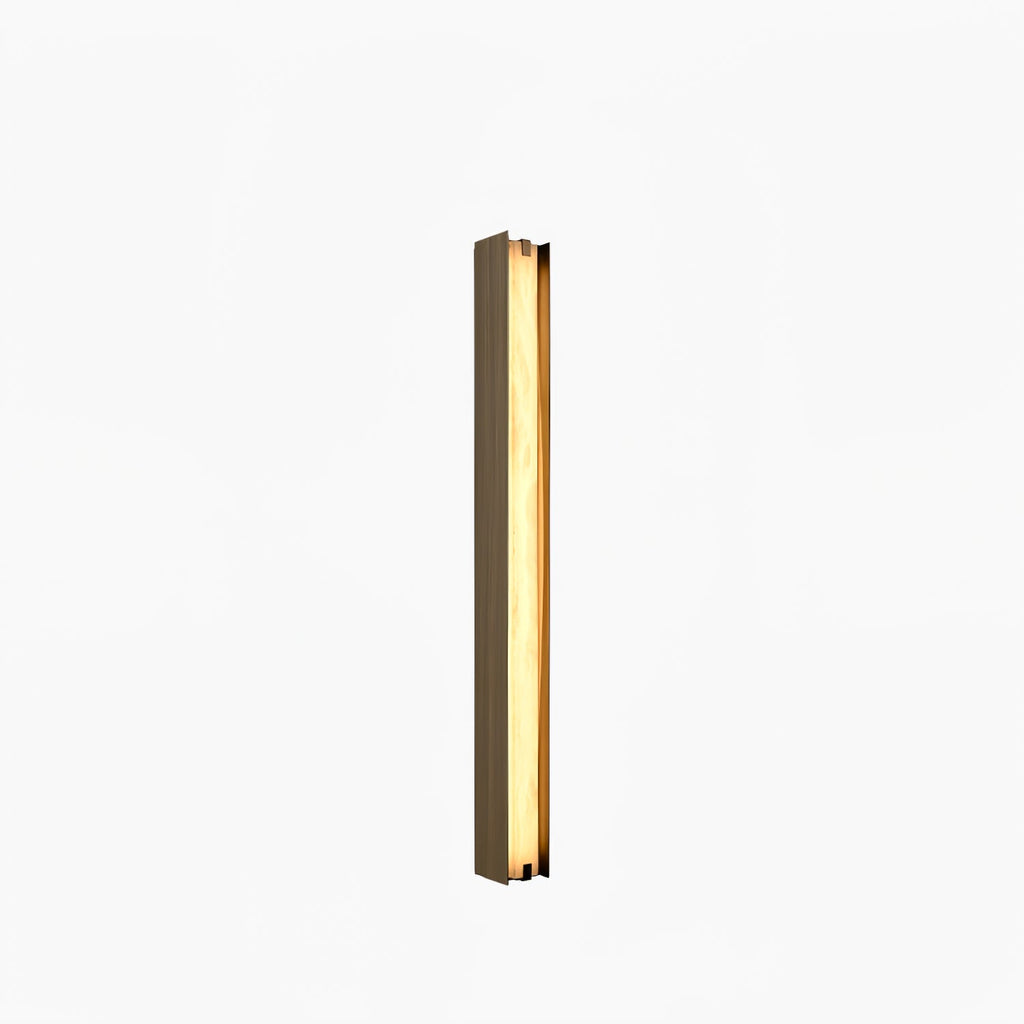 Clérachic Isolde mounted square to a white wall, a slender lit column of stone inside its bronze surround.