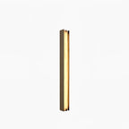 Clérachic Isolde mounted square to a white wall, a slender lit column of stone inside its bronze surround.