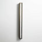 The Clérachic Isolde seen from the side on a pale wall, white alabaster catching light along the bronze edge.
