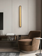 The Clérachic Isolde on a panelled living-room wall above a console, next to a brown swivel armchair.