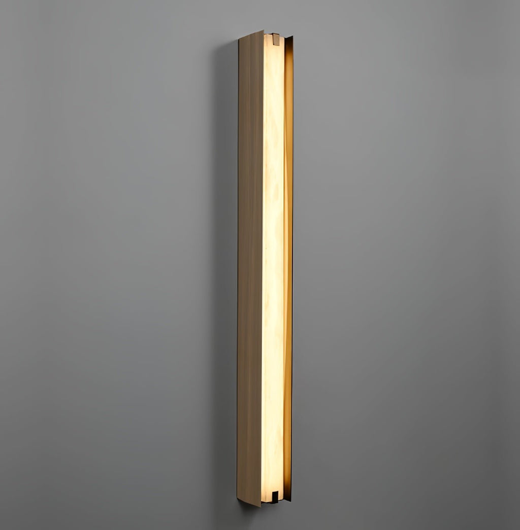 Clérachic Isolde lit on a deep grey wall, the alabaster face glowing evenly from cap to cap.