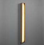 Clérachic Isolde lit on a deep grey wall, the alabaster face glowing evenly from cap to cap.