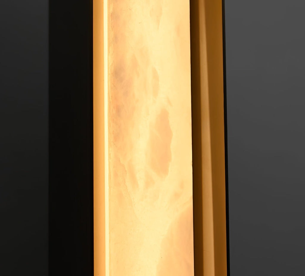 The Clérachic Isolde photographed up close while lit, alabaster turning translucent over the bronze edge.