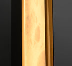 The Clérachic Isolde photographed up close while lit, alabaster turning translucent over the bronze edge.