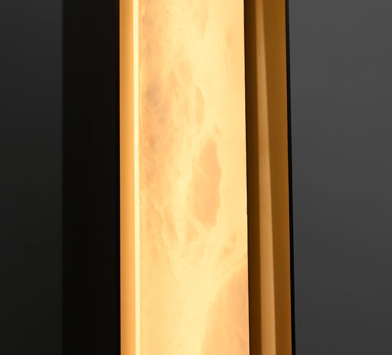 The Clérachic Isolde photographed up close while lit, alabaster turning translucent over the bronze edge.
