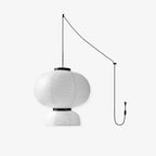 Clérachic paper pendant lamp with a rounded oval shade overhanging the dome below, pictured unlit beside the same two-hook cord run and plug.