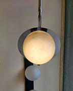 Clérachic Ivvaros lit close up, the alabaster dome glowing warm amber inside its polished chrome cup.