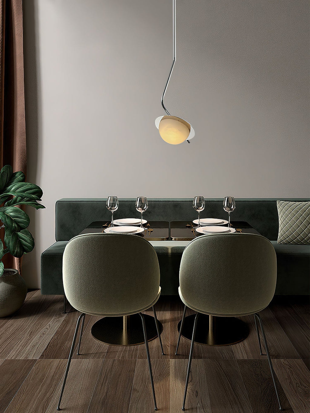 Clérachic Ivvaros pendant above a dining nook, dropped low over a green velvet banquette and laid table.