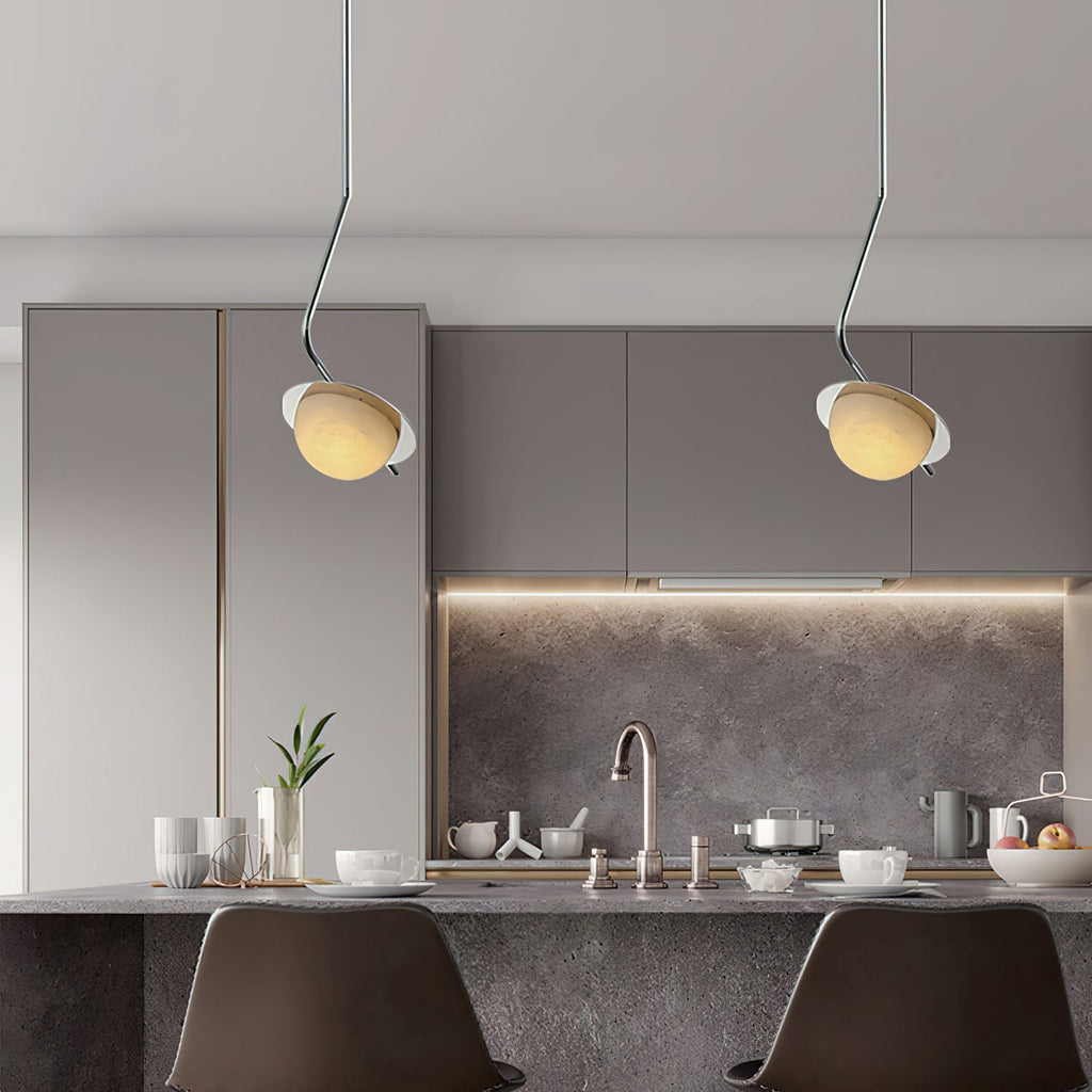Clérachic Ivvaros pendants paired over a grey kitchen island, each shade angled toward the worktop.