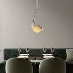 The Clérachic Ivvaros pendant centred over a laid dining table, throwing soft light onto the glassware.