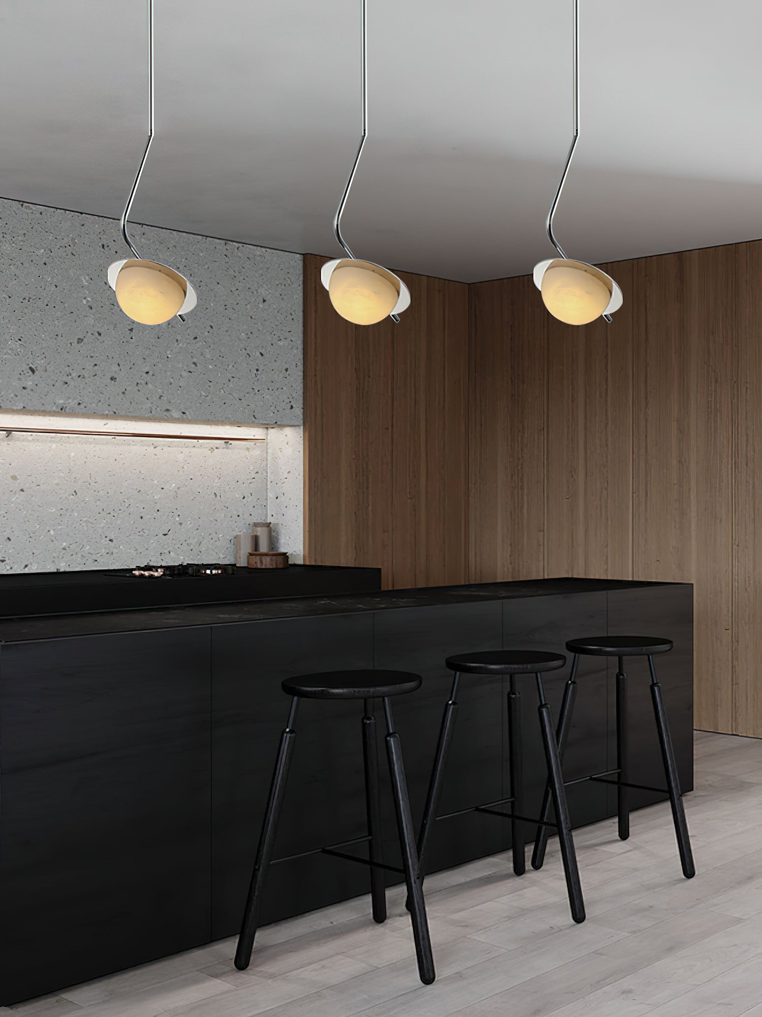 Clérachic Ivvaros pendants in a run of three above a black bar, walnut panelling behind them.