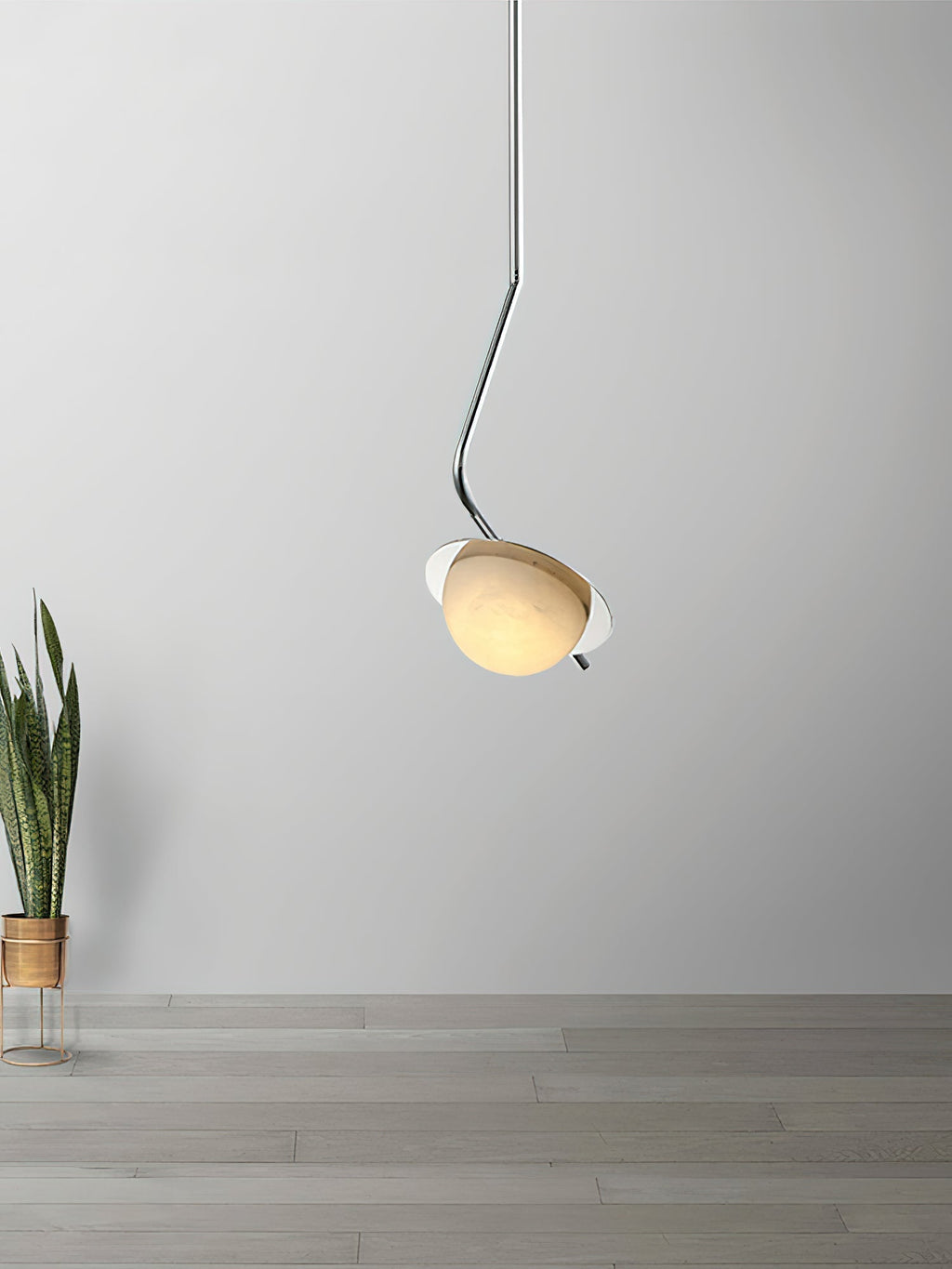 The Clérachic Ivvaros pendant against a plain wall, chrome stem hooking the alabaster shade forward.