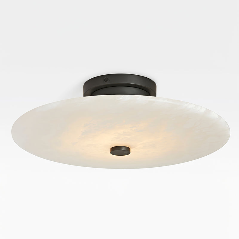 The Clérachic flush mount in the black finish, matte hardware and centre cap against a pale alabaster shade.