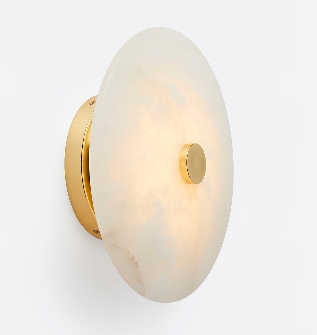 The Clérachic fixture turned edge on, showing how shallow the alabaster disc sits on its brass mount.