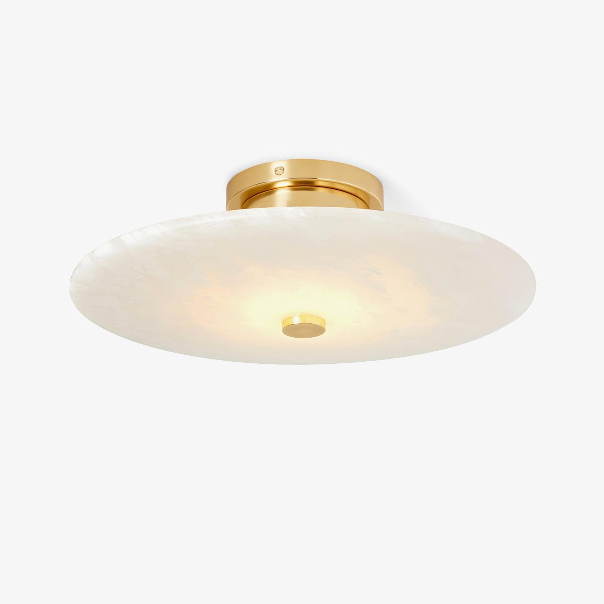 The Clérachic brass version from below, its lit alabaster disc reading softly cream right across the face.