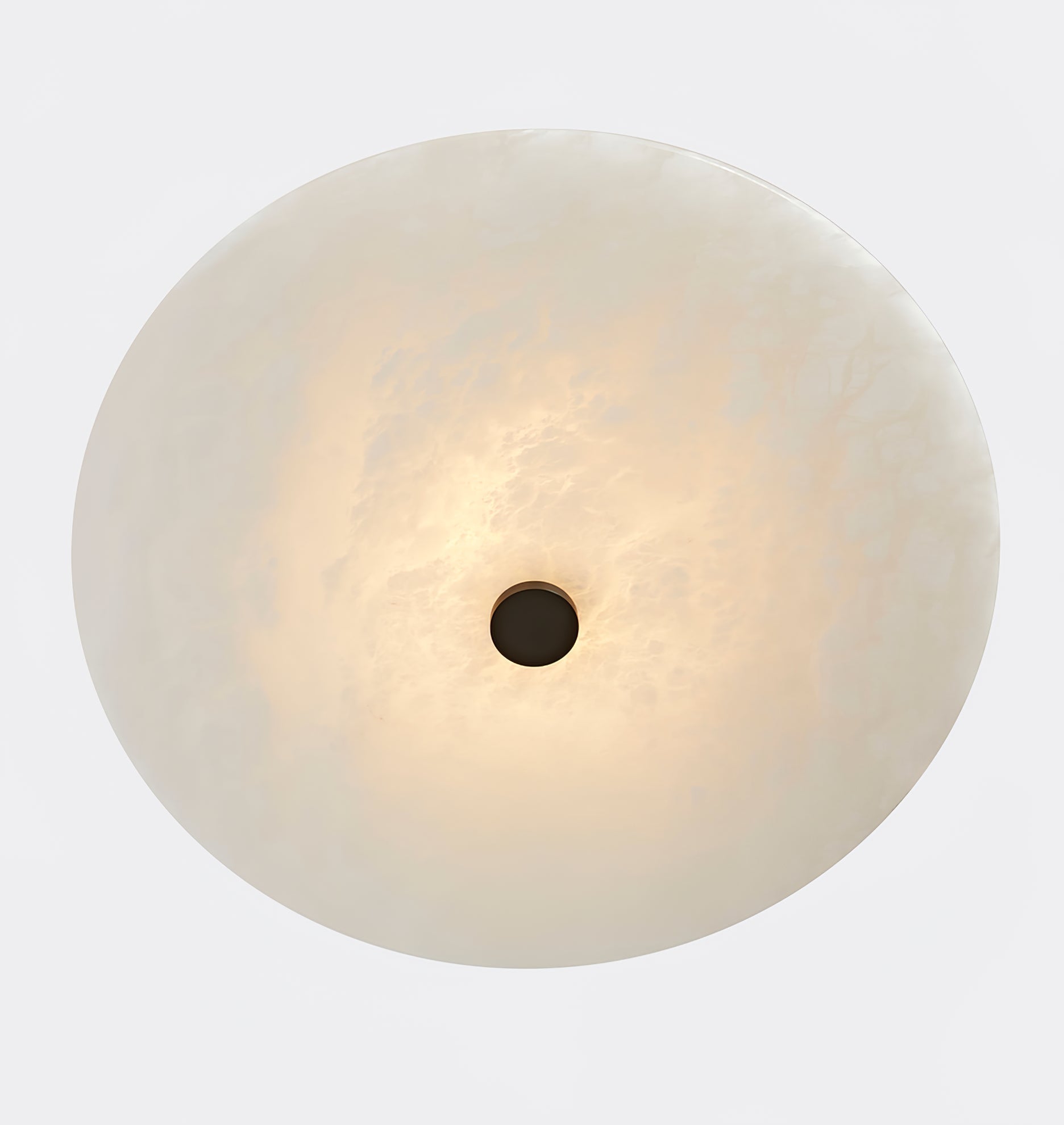 Clérachic flush mount face on, a full round of backlit alabaster centred on a small dark cap.
