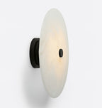 Clérachic alabaster disc shown in profile on its black mount, a slim shade held barely off the surface.