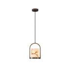 Clérachic Jewel Pendant Light shown full length on white, the alabaster shade held in its arched frame on a long black cord.