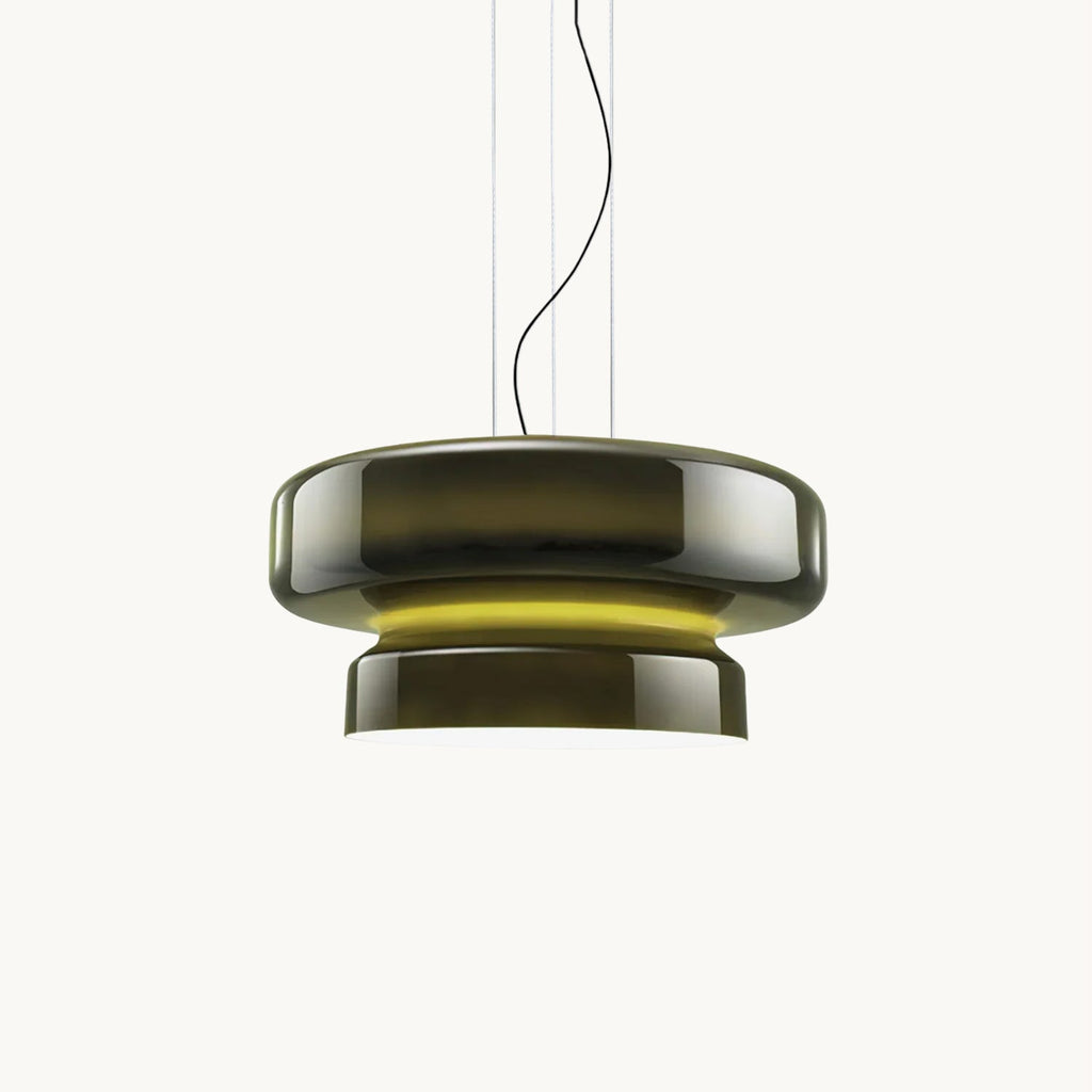 A Clérachic dark green glass pendant with a yellow-green glow between its two tiers, on a plain white backdrop.