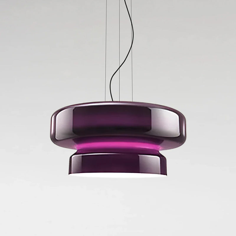 A Clérachic pendant in Purple glass, with a bright magenta band between its two tiers, on a pale grey backdrop.