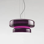 A Clérachic pendant in Purple glass, with a bright magenta band between its two tiers, on a pale grey backdrop.