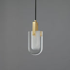 A Clérachic pendant with a U-shaped clear glass shade, a frosted inner liner and a brass bracket, unlit on a grey backdrop.