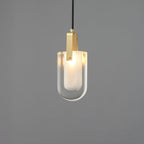 The U-shaped glass Clérachic pendant lit softly, with its frosted inner liner glowing inside the clear outer shade.