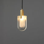 The U-shaped glass Clérachic pendant lit brighter, with a warm white glow through the frosted inner liner.