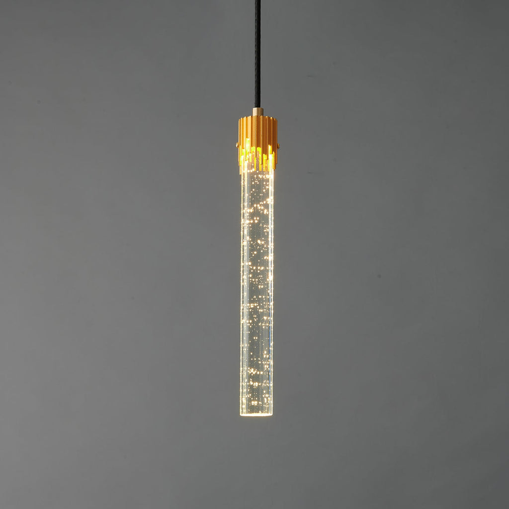 The bubble-glass rod Clérachic pendant lit, with tiny points of light in the clear glass below the brass cap.