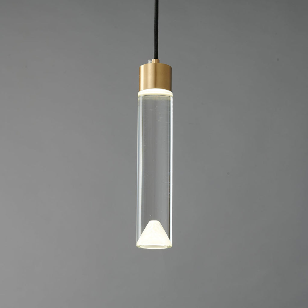 The lit cylinder Clérachic pendant on a dark grey backdrop, with the glow concentrated at both ends of the clear glass.