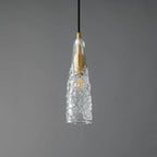 A Clérachic pendant with a crinkled, ice-textured clear glass shade tapering to a point around a brass fitting.