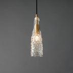 Close view of the lit crinkled glass Clérachic pendant, with the bulb glowing through the textured clear shade.
