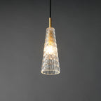 A brighter view of the lit diamond-patterned Clérachic pendant, with a warm centre glow and a brass fitting above.