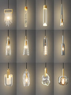 A grid of twelve Clérachic pendants in a portrait layout, with clear, ribbed, smoke grey and rock-textured glass shades.