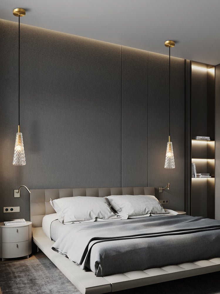 A taller view of a bedroom with two textured clear glass Clérachic pendants hanging on either side of the bed.