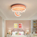 Clérachic round pink ceiling light with a glowing crescent moon and hanging stars above a bed in a soft pink child's room.