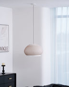 Clérachic wide dome knit pendant lamp unlit in daylight, the pinstripe clear and the ceiling canopy and full cord above it.