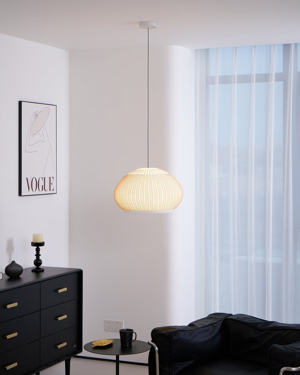 Clérachic wide dome knit pendant lamp lit warm, shown from the ceiling canopy down the full drop of its cord.