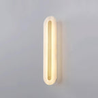Clérachic Kristy wall lamp lit on grey, brass bar running the length of the alabaster.