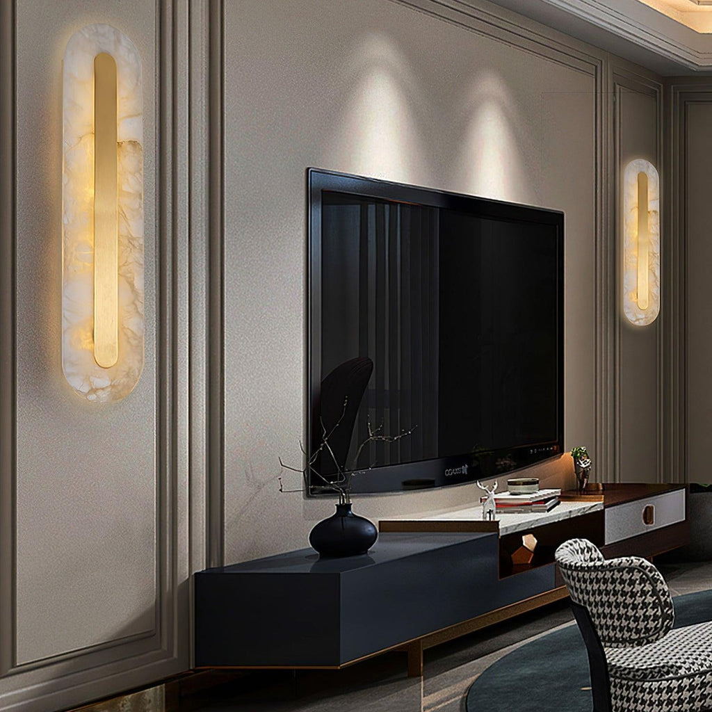 Two Clérachic Kristy wall lamps flanking a wall-mounted television above a black console.