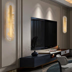 Two Clérachic Kristy wall lamps flanking a wall-mounted television above a black console.